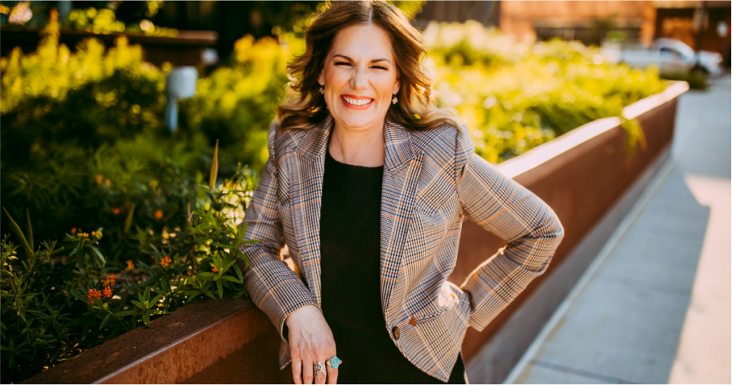 Jane Kleeb standing and smiling at the camera